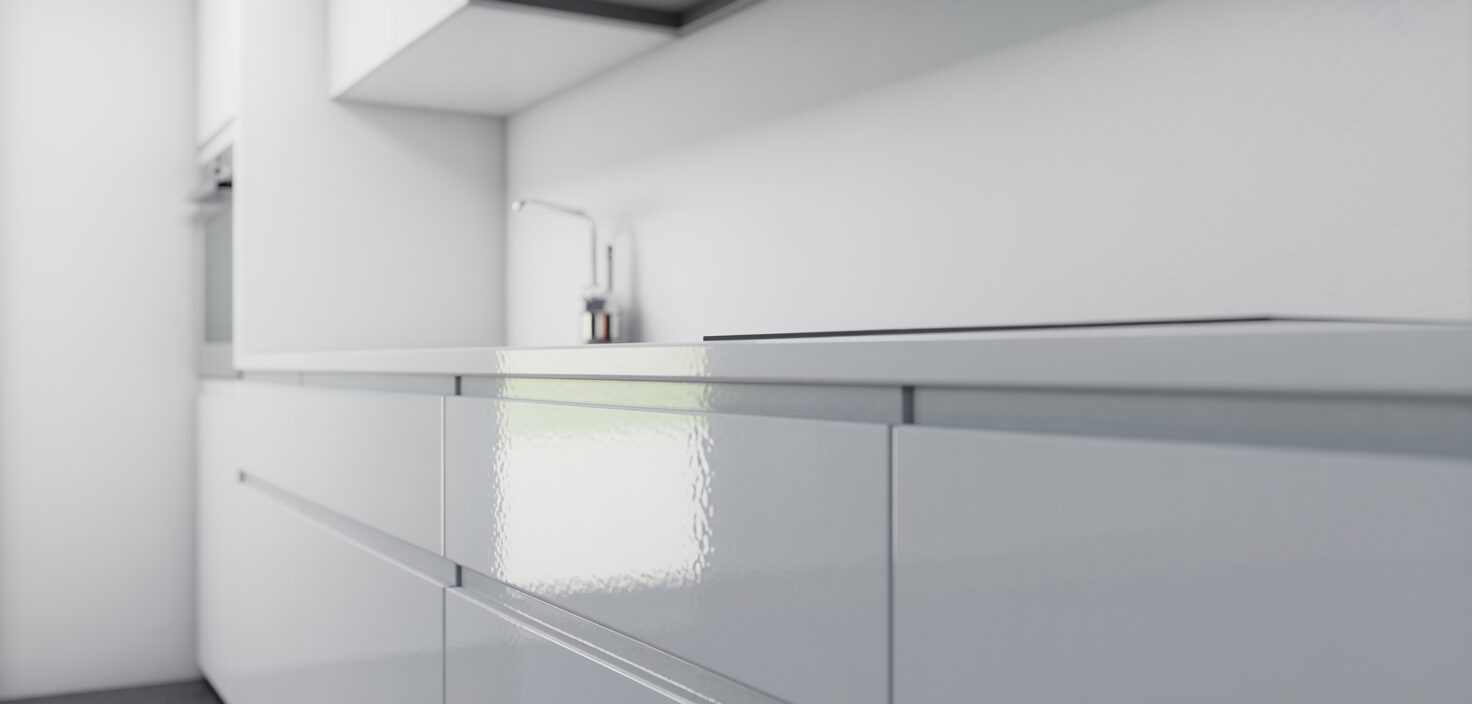 Minimalistiskt vitt kök med slät skåpslucka i närbild, rent och stilrent.