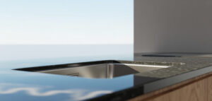 Undermonterad diskho i rostfritt stål med granitskiva. Rent och minimalistiskt.