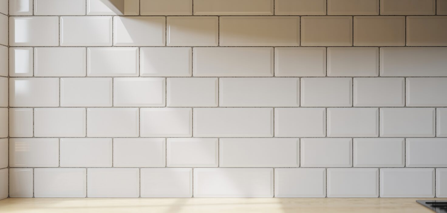 Närbild av vitt kakel i minimalistiskt kök, rent och snyggt.